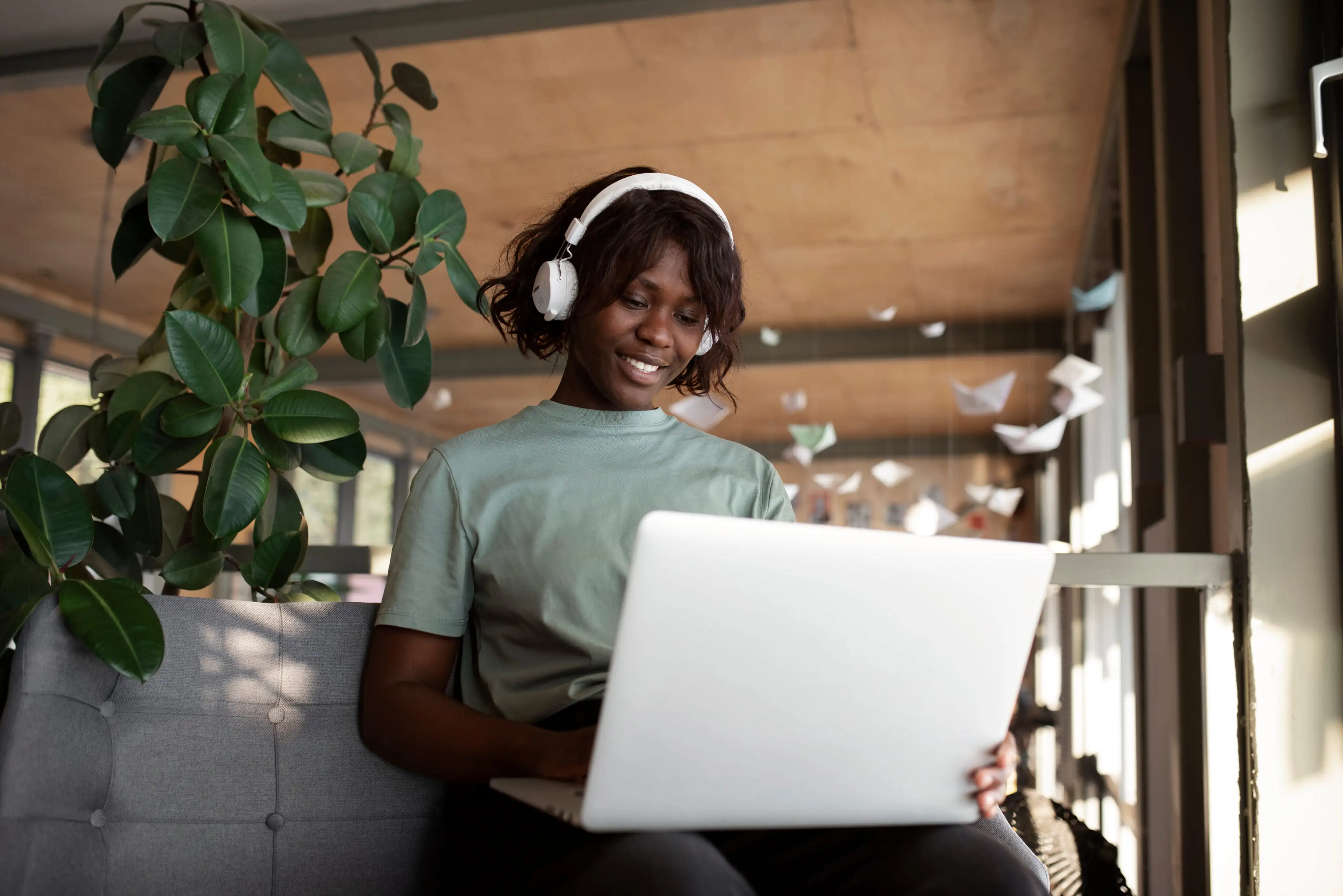 A remote worker smiling at her laptop